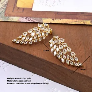 Exaggerated angel wing stud earrings with pavé zircons in 18k gold plated copper