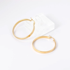 Close-up of classic gold stainless steel hoop earrings with polished metallic finish