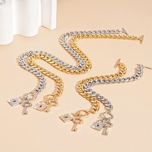 Close-up of Cuban link bracelets with rhinestone padlock and key charms and OT toggles
