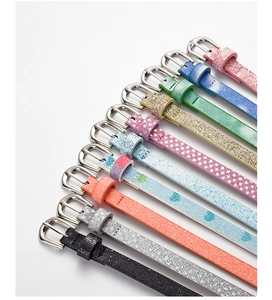 Detail view of assorted glitter and star pattern PU belts with silver metal buckles