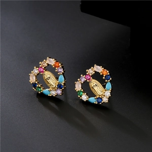 Detailed shot of golden heart earrings with colorful zircon and Virgin Mary relief