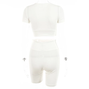 Close-up of white ribbed two-piece set featuring short crop top and high waist shorts