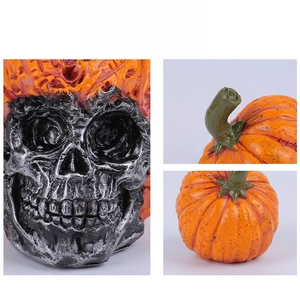 Detailed views of a resin Halloween skull wearing a textured orange pumpkin hat decoration