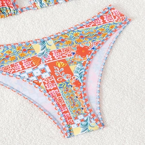 Bohemian printed bikini bottom with vibrant floral patterns and braided waist edges