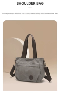 Detail of grey canvas shoulder bag featuring round leather logo and adjustable strap
