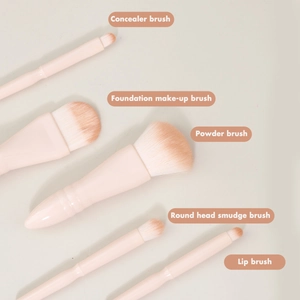 Detail view of 5-piece pink travel makeup brush set with functional English labels