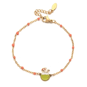 Macro detail of a golden stainless steel chain with pink beads and a coconut charm