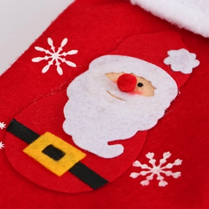 Detail of red felt Christmas stocking with Santa Claus applique and snowflake embroidery