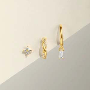 Macro view of gold-plated silver earrings set with rectangular and round zirconia