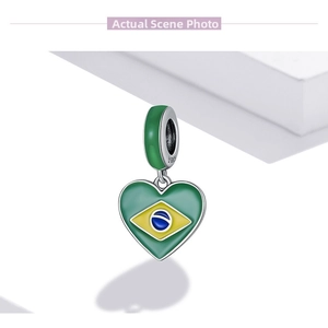 Macro shot of S925 sterling silver heart charm with Brazilian flag enamel detail