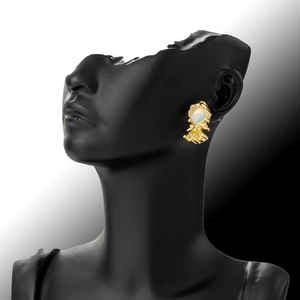 Golden fishtail earring with white zircon on a model for a sweet, minimalist aesthetic