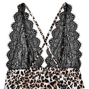 Detail of black lace trim and leopard print satin fabric on backless mini dress