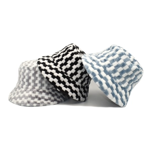 Plush checkerboard bucket hats in black, blue, and grey for winter warmth and fashion