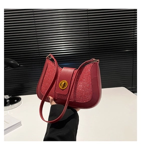 Detail of red sequin shoulder bag featuring golden rotary buckle and glossy PU leather trim