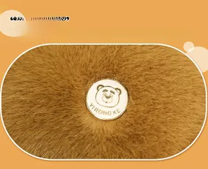 Detail shot of the plush capybara fabric with a custom bear logo badge on brown fur
