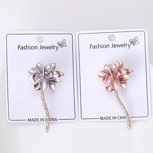 Detail showing lavender and pink enamel flower pins with rhinestone-inlaid long stems