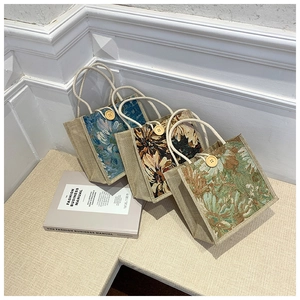 Detail view of linen handbags featuring vintage floral patterns and wooden buckle details