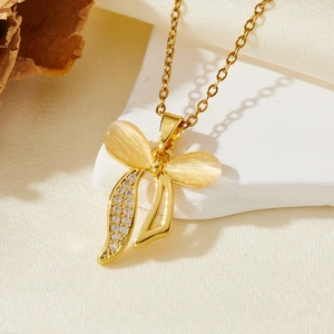 Collier élégant avec pendentif nœud doré, pierres opales et cristaux sur fond de soie
