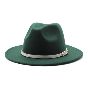 Detail view of a dark green fedora hat with a contrasting white belt and gold buckle