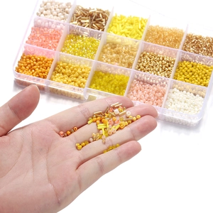15-compartment glass bead set for DIY jewelry with yellow, orange, and gold beads
