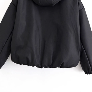 Women's black hooded puffer jacket in urban techwear style with windproof fabric