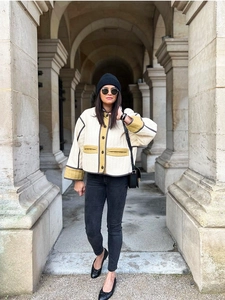 Close-up of diamond-quilted texture and mustard contrast piping on cropped jacket