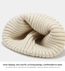 Detailed close-up of the beige knit beanie showing the non-fleece interior structure