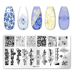 Detail of rectangular nail stamping plate with floral vine patterns and finished nail tips