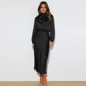 Elegant black satin halter dress with cinched waist and graceful floor-length drape
