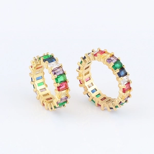 Macro view of two rainbow gold eternity rings with colorful rectangular zircon stones