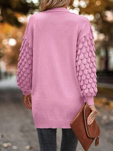 Close-up of pink V-neck knit cardigan showing unique petal texture sleeves and long cut
