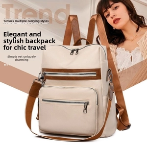 Close-up of cream white lychee-patterned PU leather backpack with dark brown fabric straps