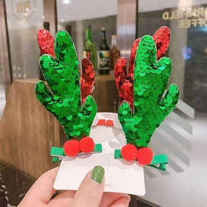 Christmas reindeer antler hair clips with red and green sequins and plush ball accents