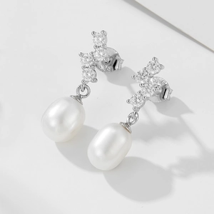 Detailed macro view of S925 sterling silver waterdrop pearl earrings with zircon inlay