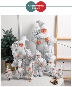 Detail of silver Santa Claus figurines in various sizes and festive poses for decoration