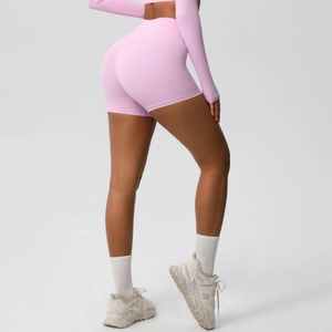 Detail view of high waisted light pink fitness shorts with seamless push-up shaping effect