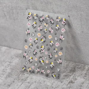 Detail of embossed nail art stickers featuring vintage birds, roses and clock patterns