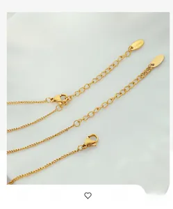 Macro shot of 18k gold plated stainless steel lobster clasp and adjustable tail chain