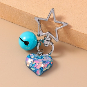 Star-shaped clasp keychain with turquoise bell and blue resin heart filled with sequins