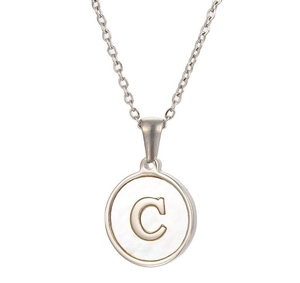 Macro detail of silver necklace featuring a round white shell pendant with gold letter C