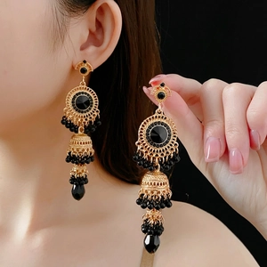 Vintage gold-tone drop earrings featuring black teardrop crystals and beaded tassels