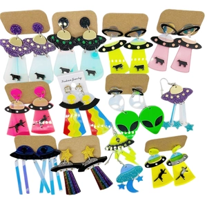 Collection of colorful acrylic alien and UFO earrings with rainbow and glitter stars
