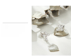 Detailed close-up of S925 silver cross stud earrings with sparkling cubic zirconia stones