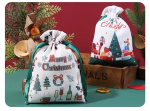 Detail of Christmas drawstring gift bags with Santa and tree motifs on red background