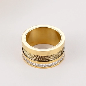 Detailed view of gold steel ring with roman numerals, wire texture and zircon row