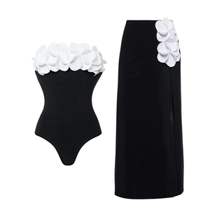 Detail of elegant 3D white floral appliques on black one-shoulder swimwear set
