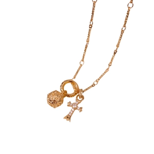 Vintage gold necklace featuring a hollow ball and zircon cross pendant on a textured chain