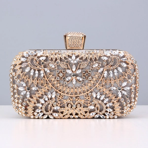 Detailed close-up of golden floral metal hollow out patterns with crystals on evening clutch