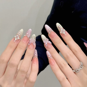 Pink cat eye press-on nails with 3D butterfly, pearls and silver glitter almond shape