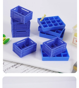 Detailed view of blue miniature plastic crates and dollhouse trays for DIY toy scenery
